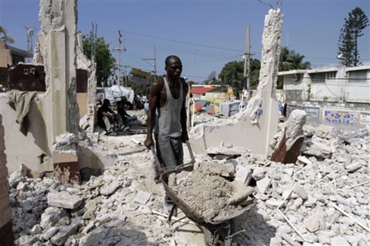 A Haitian man removes debris from a house damaged by the Jan. 12 earthquake in Port-au-Prince, Haiti, on Dec. 11. Out of every $100 of U.S. contracts now paid out to rebuild Haiti, Haitian firms have successfully won $1.60, The Associated Press has found in a review of contracts since the earthquake on Jan. 12. And the largest initial U.S. contractors hired fewer Haitians than planned. 
